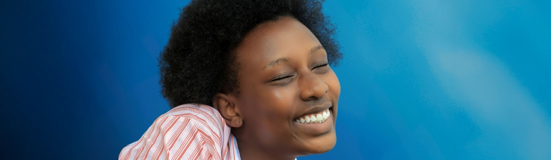Dentist Raleigh NC Woman Smiling On Blue Background Dentist Raleigh NC Woman Smiling On Blue Background